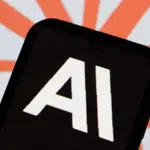 Smartphone screen displaying "AI" text against a blurred red and white background.